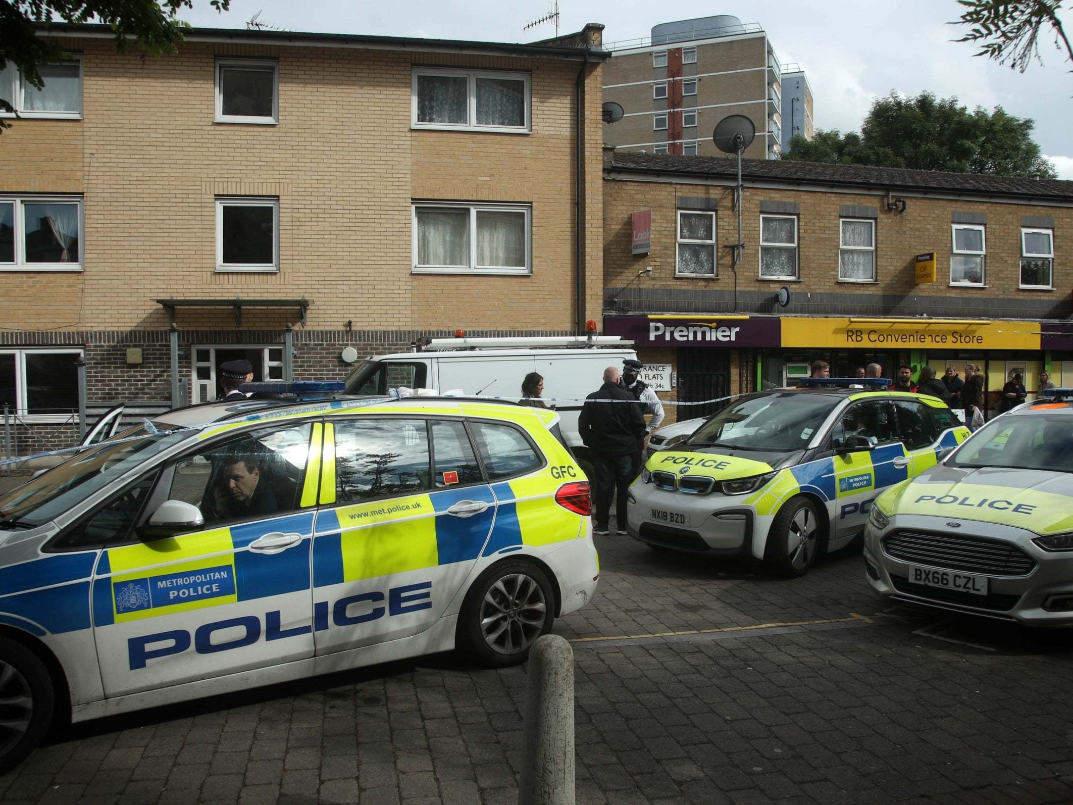 Police officers at the scene of an earlier killing in Tower Hamlets, east London, on Saturday