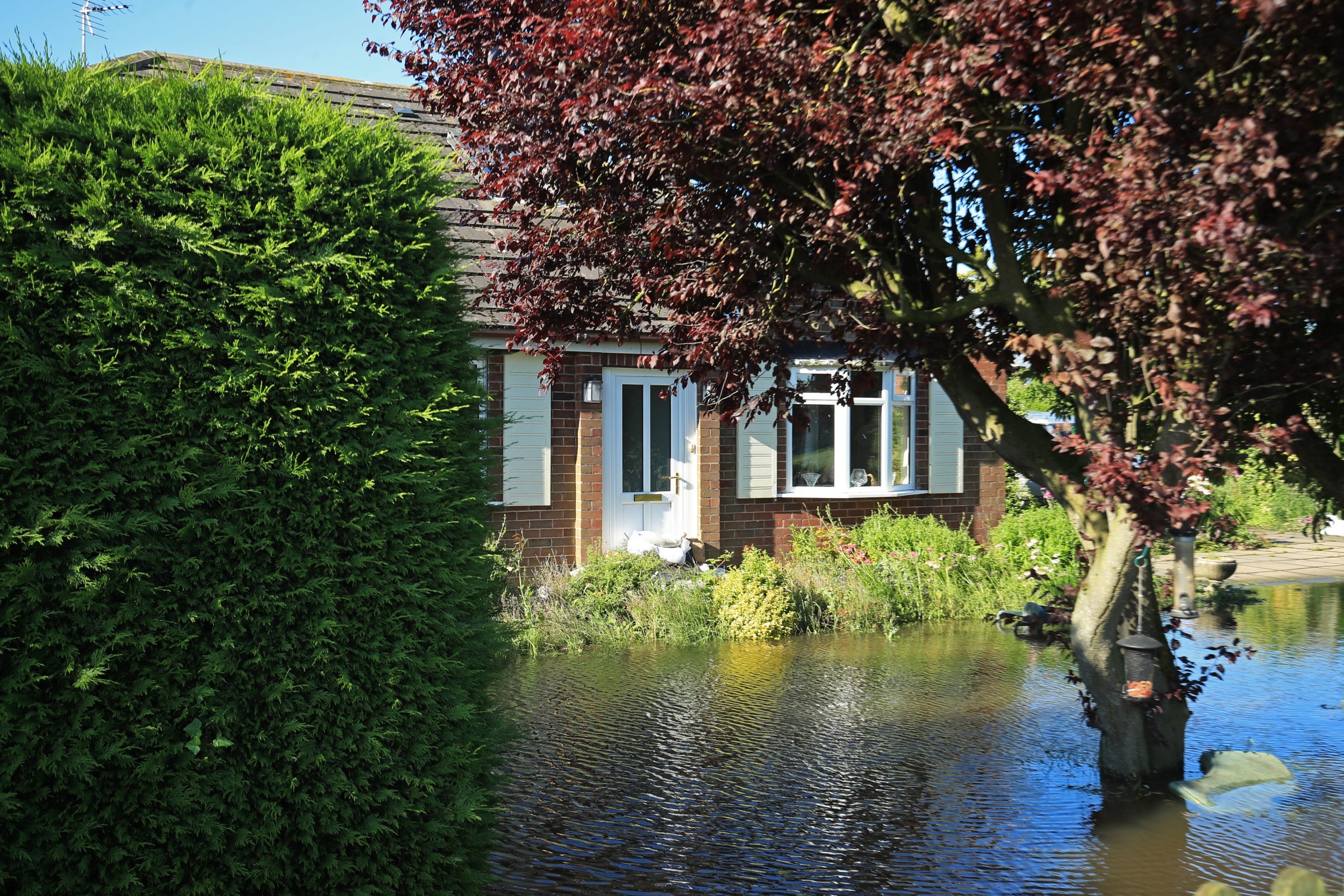 A garden submerged by floodwater in Wainfleet, where streets and properties flooded after the town had more than two months of rain in just two days