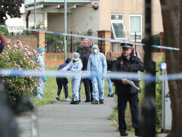Police and forensics officers at the scene of a stabbing in east London last month