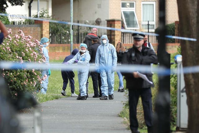 Police and forensics officers at the scene of a stabbing in east London last month