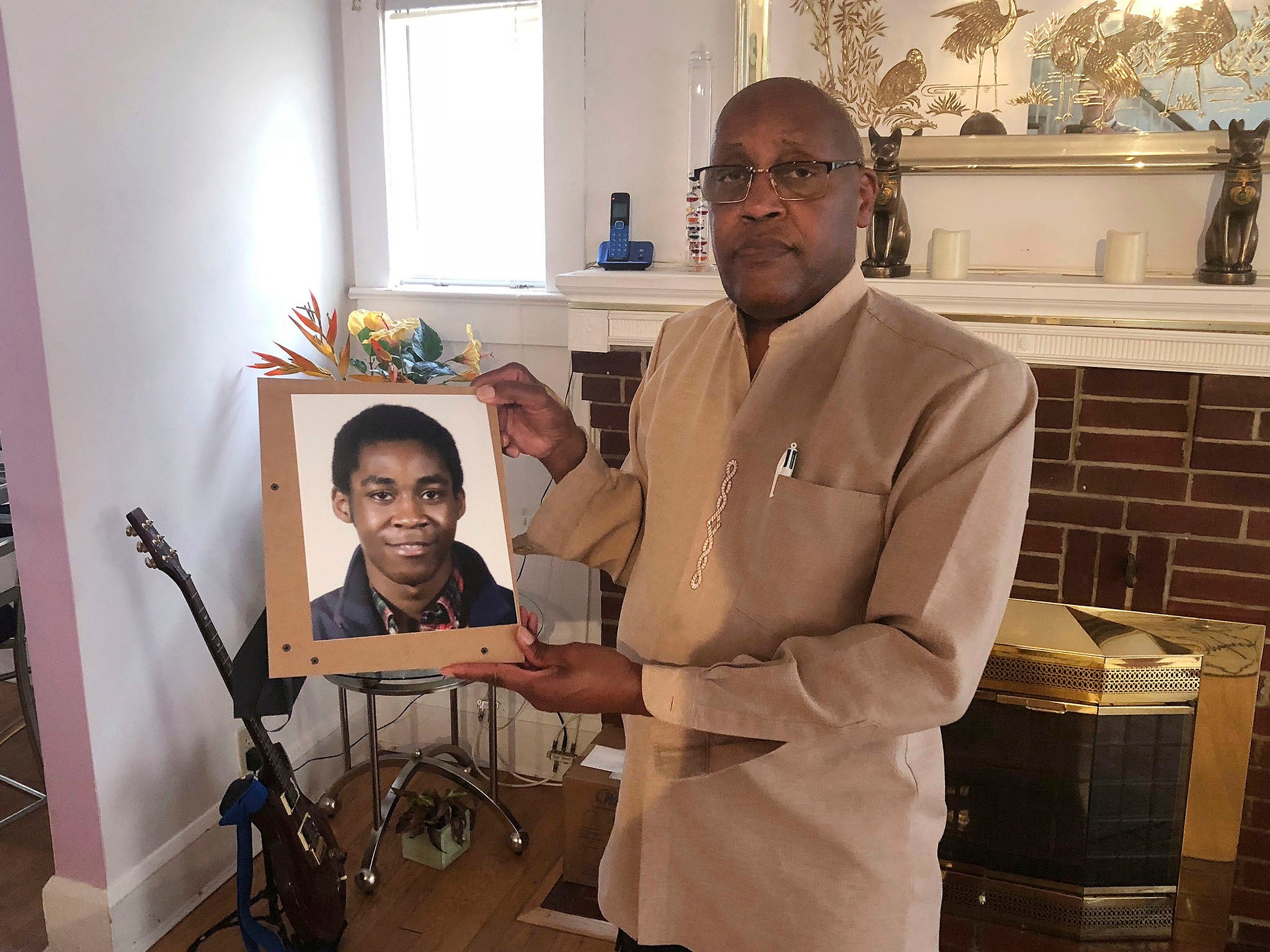 Dia Khafra, father of Askia Khafra, holds a photo of his son in his who died as he was helped Daniel Beckwitt, dig tunnels for a nuclear bunker beneath his Maryland home