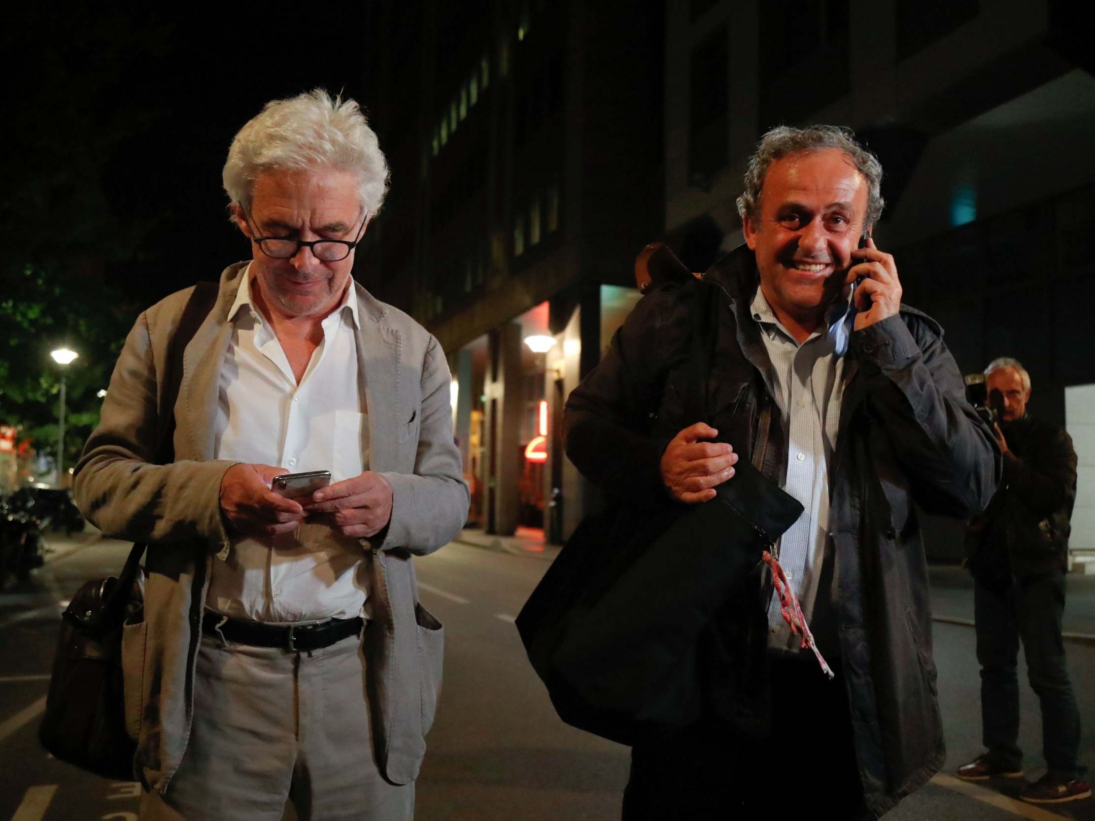 Platini leaves with his lawyer William Bourdon after being questioned by police on Tuesday