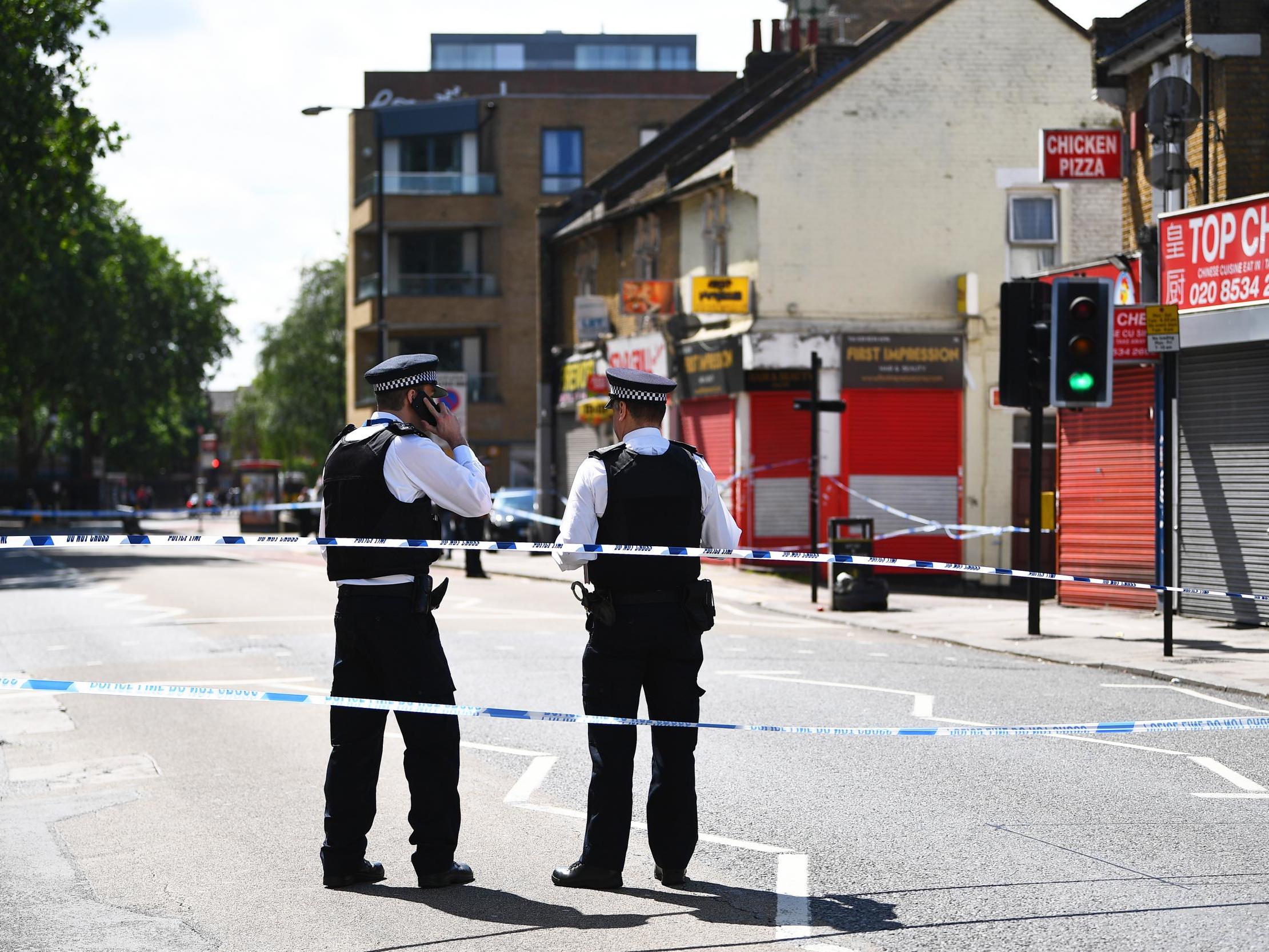 Police (pictured in Stratford on Monday) have launched several murder inquiries after five men killed in six days in London