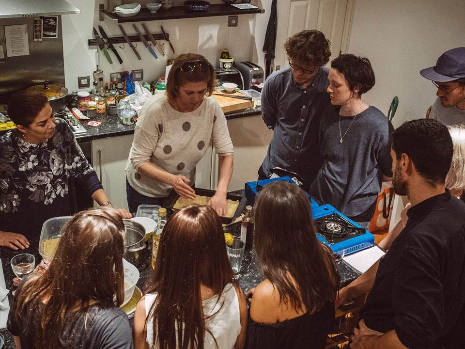 Majeda shares her cooking skills with a class