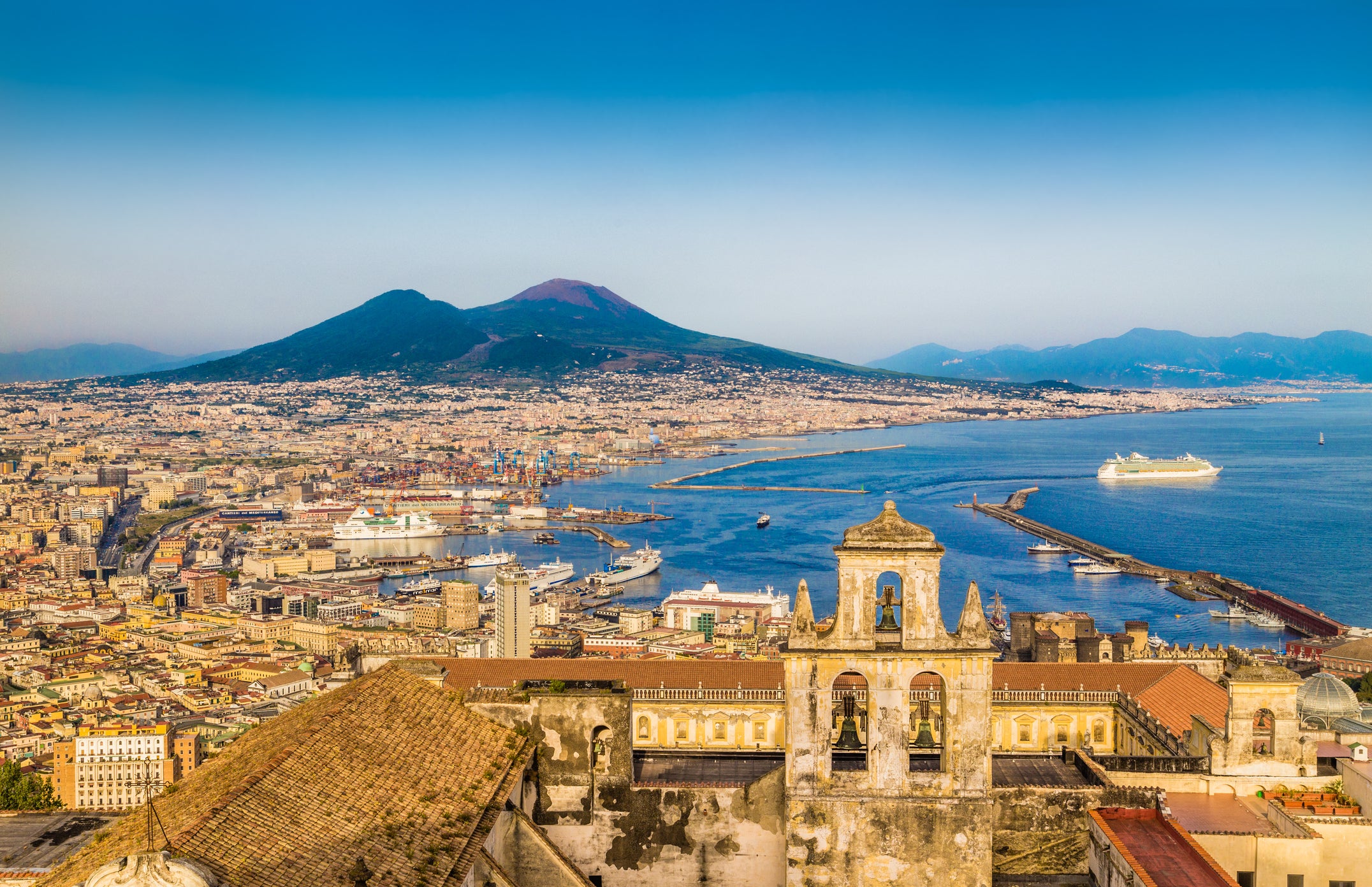 The city sits in a bay overlooking the active volcano Vesuvius