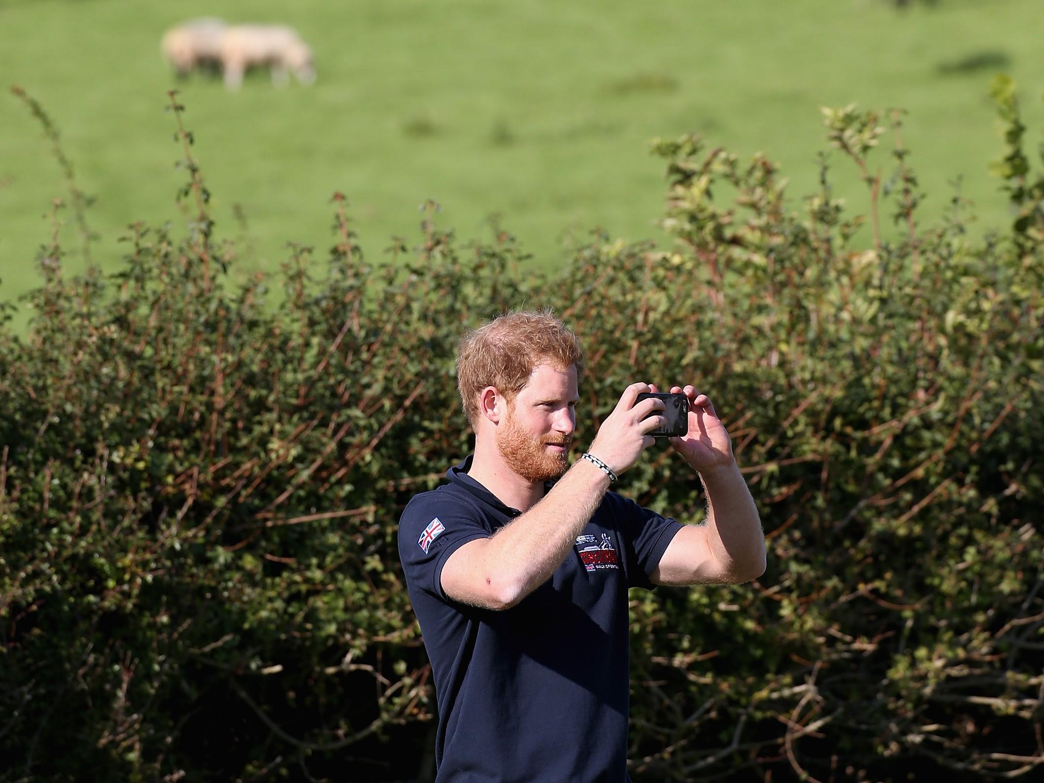 Prince Harry using a smartphone on 30 September, 2015 in Ludlow, England. The royal has warned about the addictive nature of some modern technologies