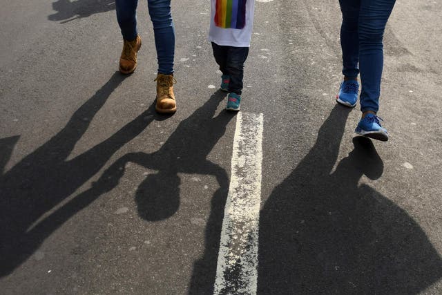 A family takes part in the Gay Pride parade