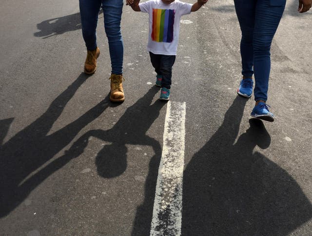 A family takes part in the Gay Pride parade