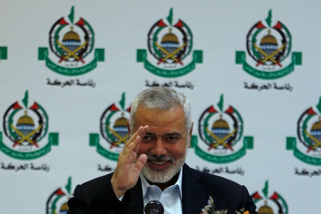 Hamas Chief Ismail Haniyeh gestures during a meeting with members of international media at his office in Gaza
