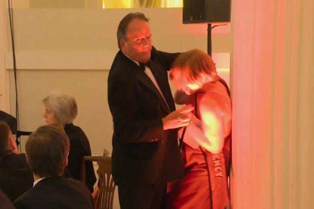 Mark Field grabs the woman around the neck