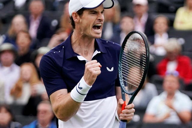 Andy Murray reacts as he plays alongside Feliciano Lopez