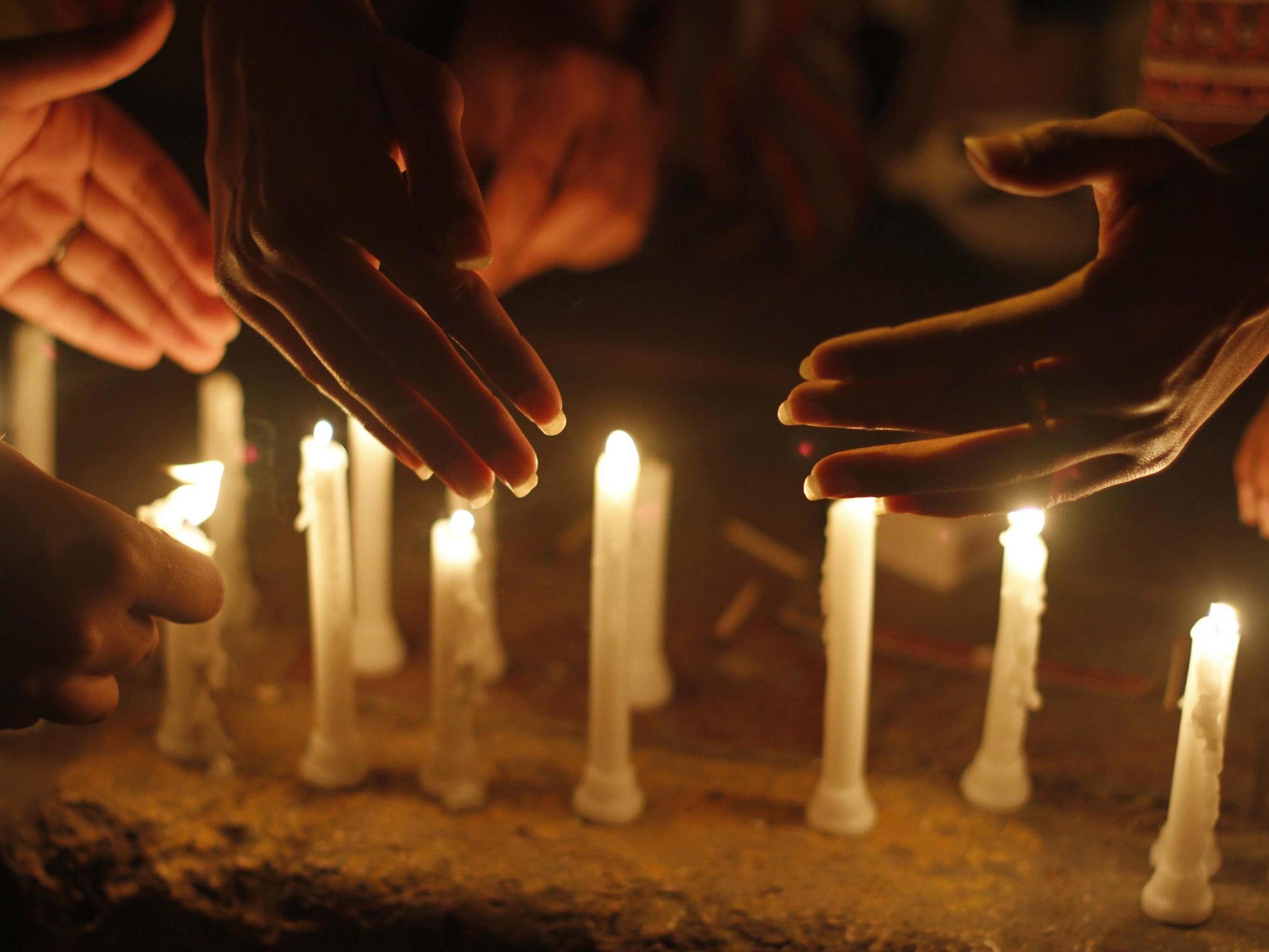 Candles are lit in Pakistan as part of peaceful gathering to end violence against women