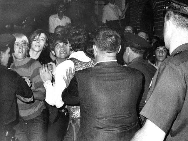 A crowd attempts to impede police arrests outside the Stonewall Inn on Christopher Street in Greenwich Village, on 28 June 1968