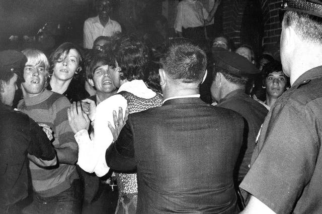 A crowd attempts to impede police arrests outside the Stonewall Inn on Christopher Street in Greenwich Village, on 28 June 1968