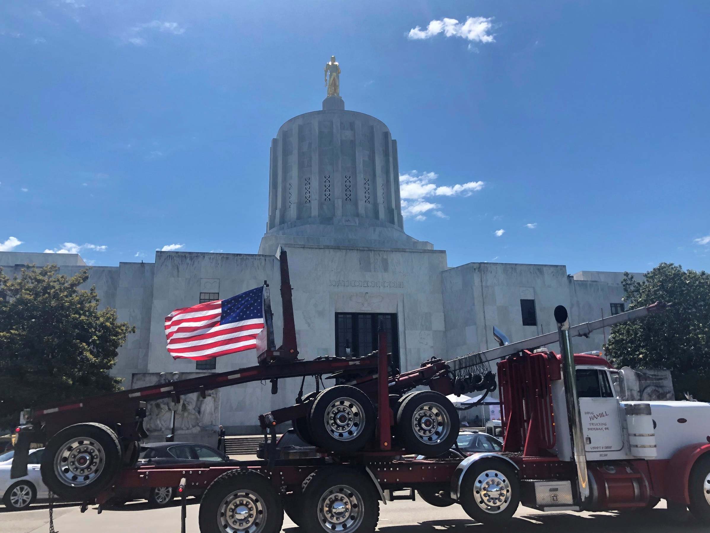 A truck drives past the Oregon state Capitol during a protest