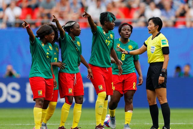 Cameroon remonstrate with the referee