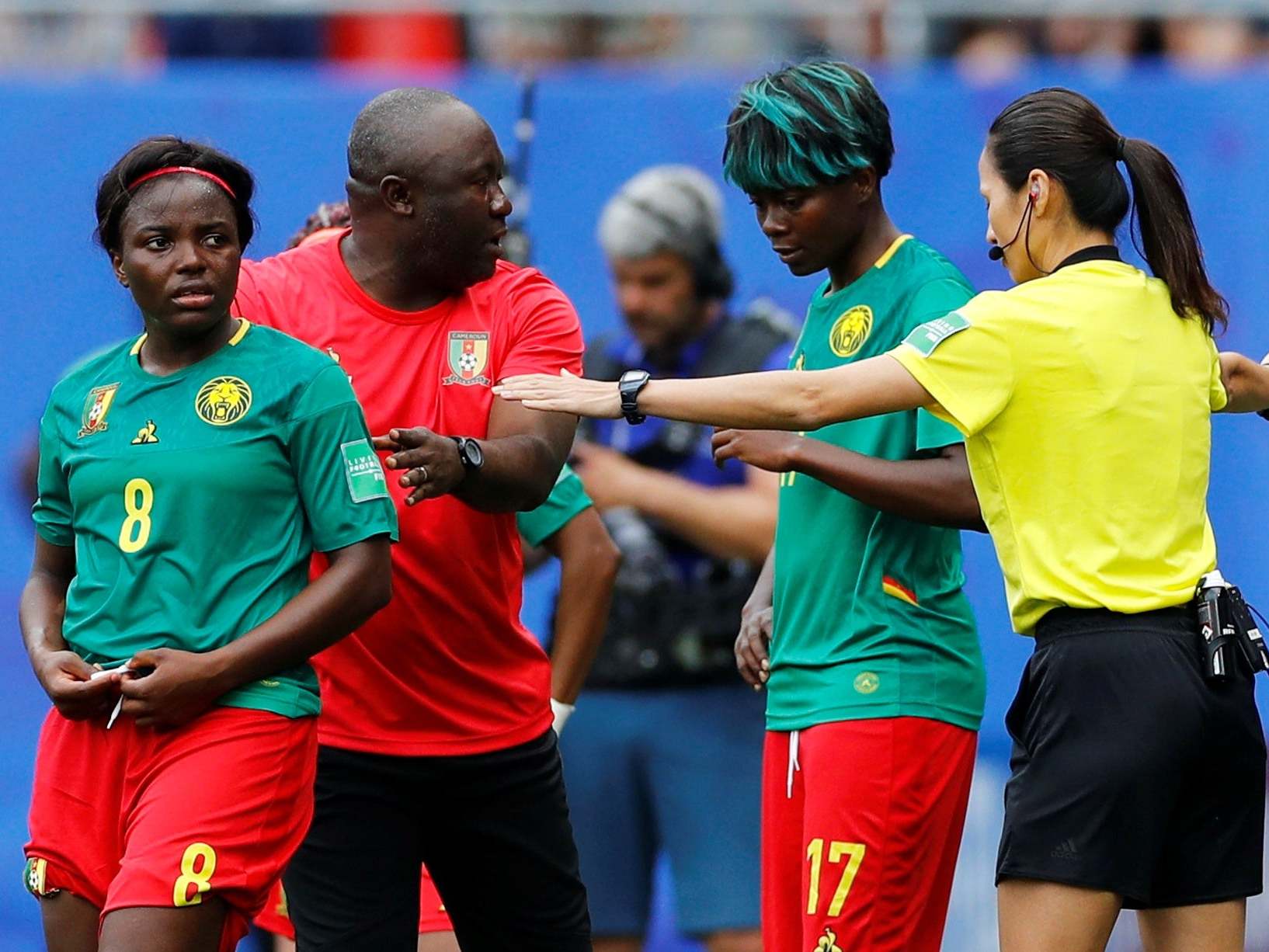 Cameroon coach Alain Djeumfa, Raissa Feudjio and Gaelle Enganamouit protest