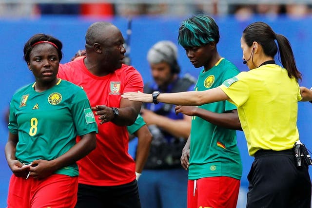 Cameroon coach Alain Djeumfa, Raissa Feudjio and Gaelle Enganamouit react after a goal is disallowed against England