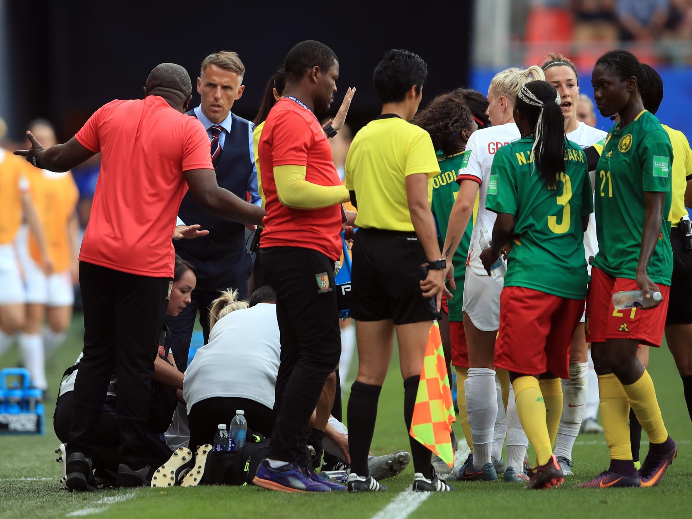 Phil Neville confronts Alain Djeumfa on the touchline during England's win over Cameroon