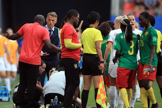 Phil Neville confronts Alain Djeumfa on the touchline during England's win over Cameroon