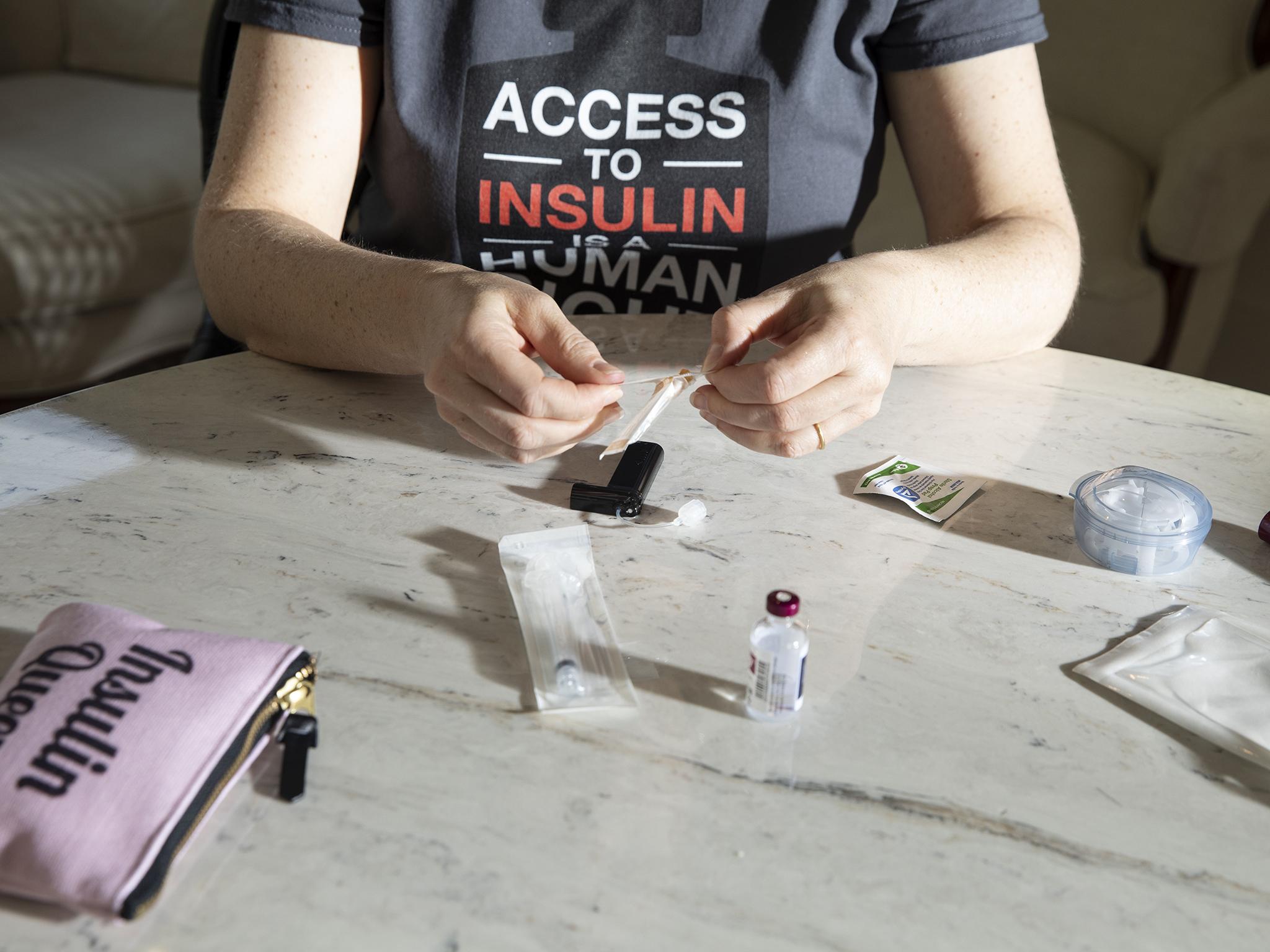 Lija Greenseid prepares to draw insulin at her Minnesota home for her daughter who has type 1 diabetes