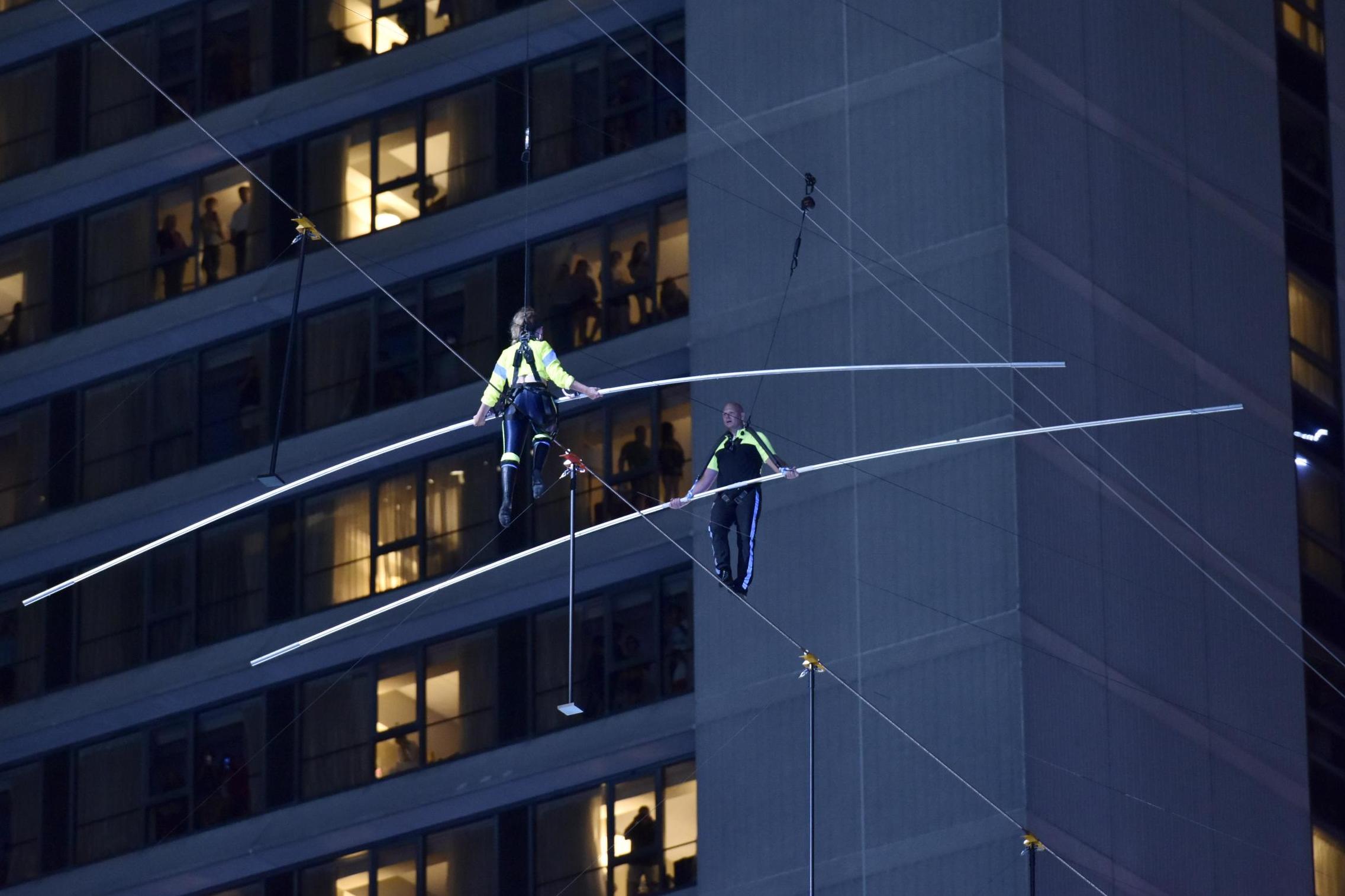 Lijana Wallenda and Nik Wallenda walk a high wire over Times Square on 23 June, 2019 in New York City.