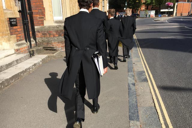 Etonian schoolboys in their traditional uniform of tails; the college would be axed if activists won their campaign