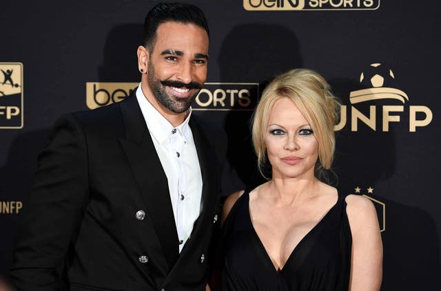 Marseille's defender Adil Rami (L) and US actress Pamela Anderson arrive to take part in a TV show on May 19, 2019 in Paris, as part of the 28th edition of the UNFP (French National Professional Football players Union) trophy ceremony.