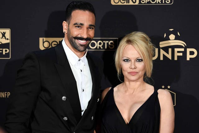 Marseille's defender Adil Rami (L) and US actress Pamela Anderson arrive to take part in a TV show on May 19, 2019 in Paris, as part of the 28th edition of the UNFP (French National Professional Football players Union) trophy ceremony.