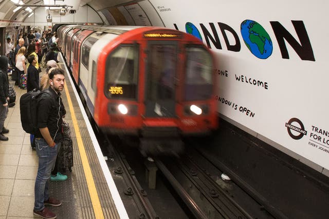 A London Underground train arrives at Oxford Circus station