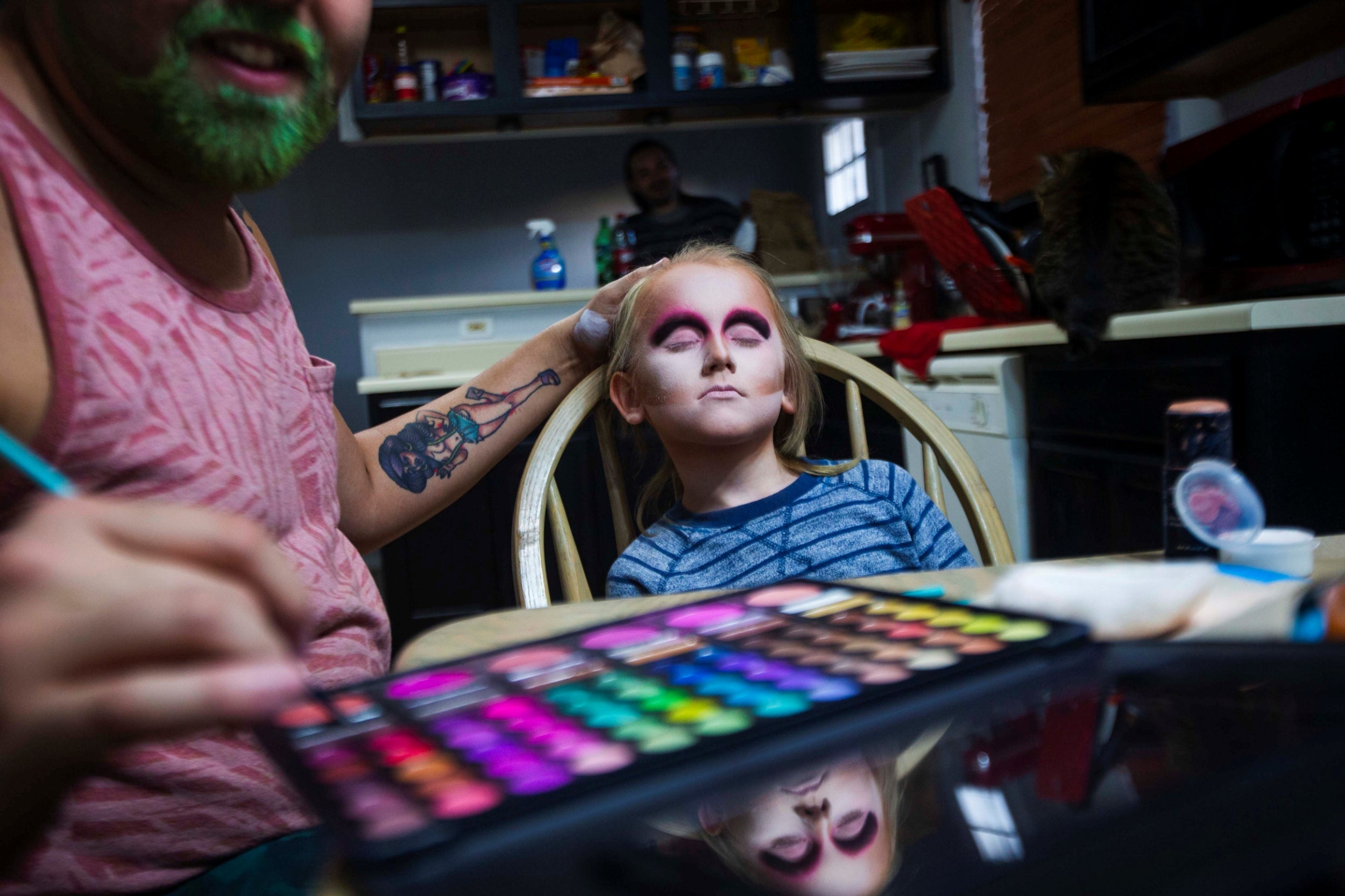 Robby, a drag queen, applies makeup on Keegan