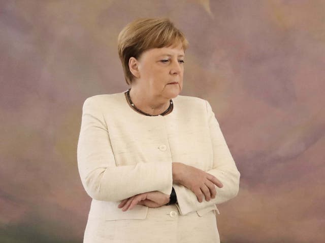 German Chancellor Angela Merkel appears to shake during a ceremony at the presidential Bellevue Palace in Berlin