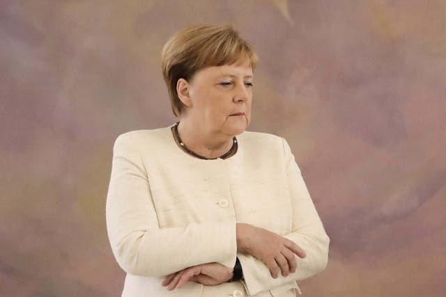 German Chancellor Angela Merkel appears to shake during a ceremony at the presidential Bellevue Palace in Berlin