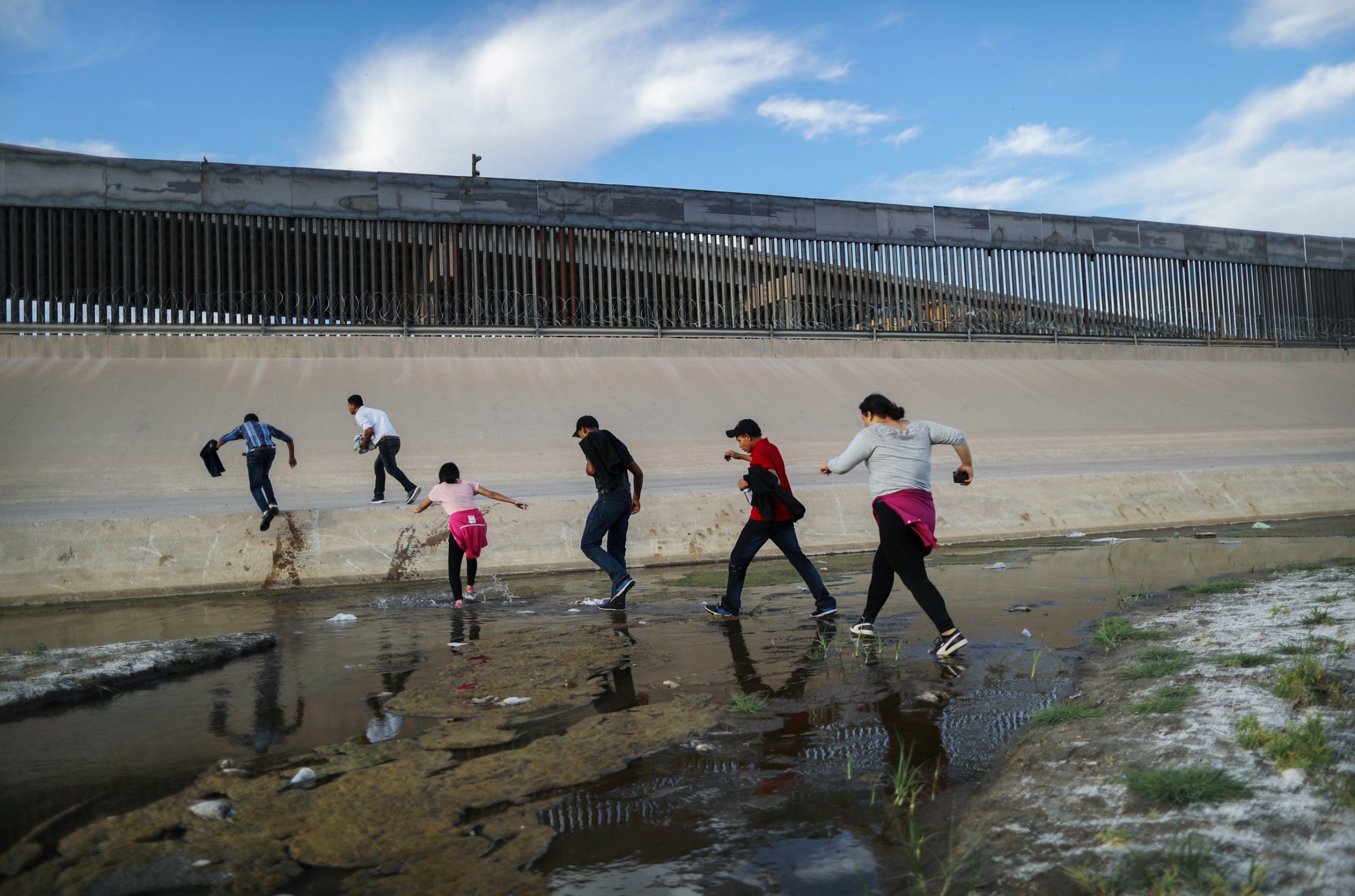 Migrants cross the Rio Grande into the United States on 19 May 2019. Approximately 1,000 migrants per day are being released by authorities in the El Paso sector of the US-Mexico border