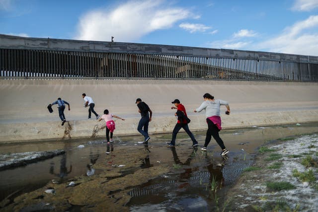 Migrants cross the Rio Grande into the United States on 19 May 2019. Approximately 1,000 migrants per day are being released by authorities in the El Paso sector of the US-Mexico border