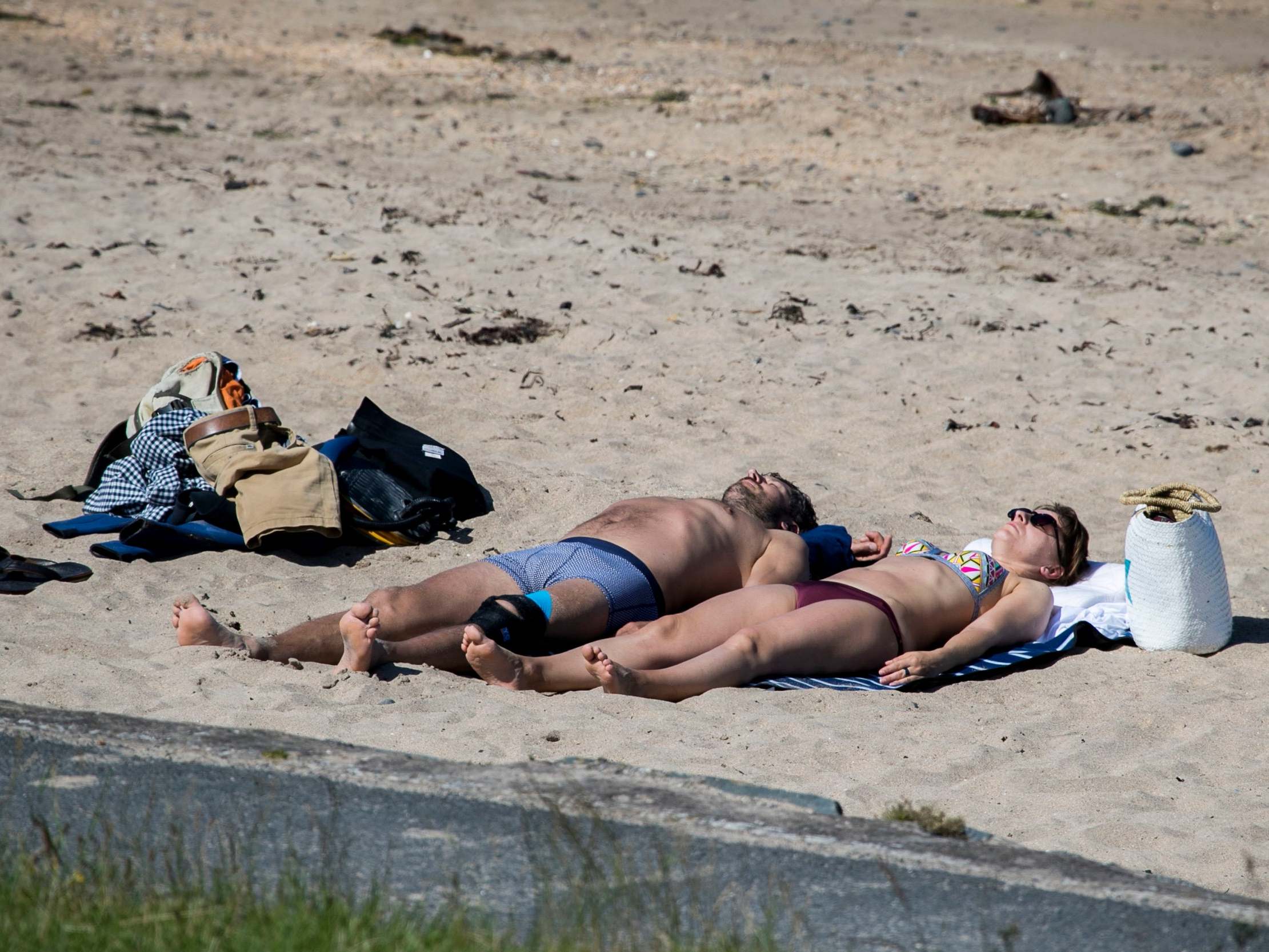 People enjoying the summer weather at Helens Bay beach in Northern Ireland