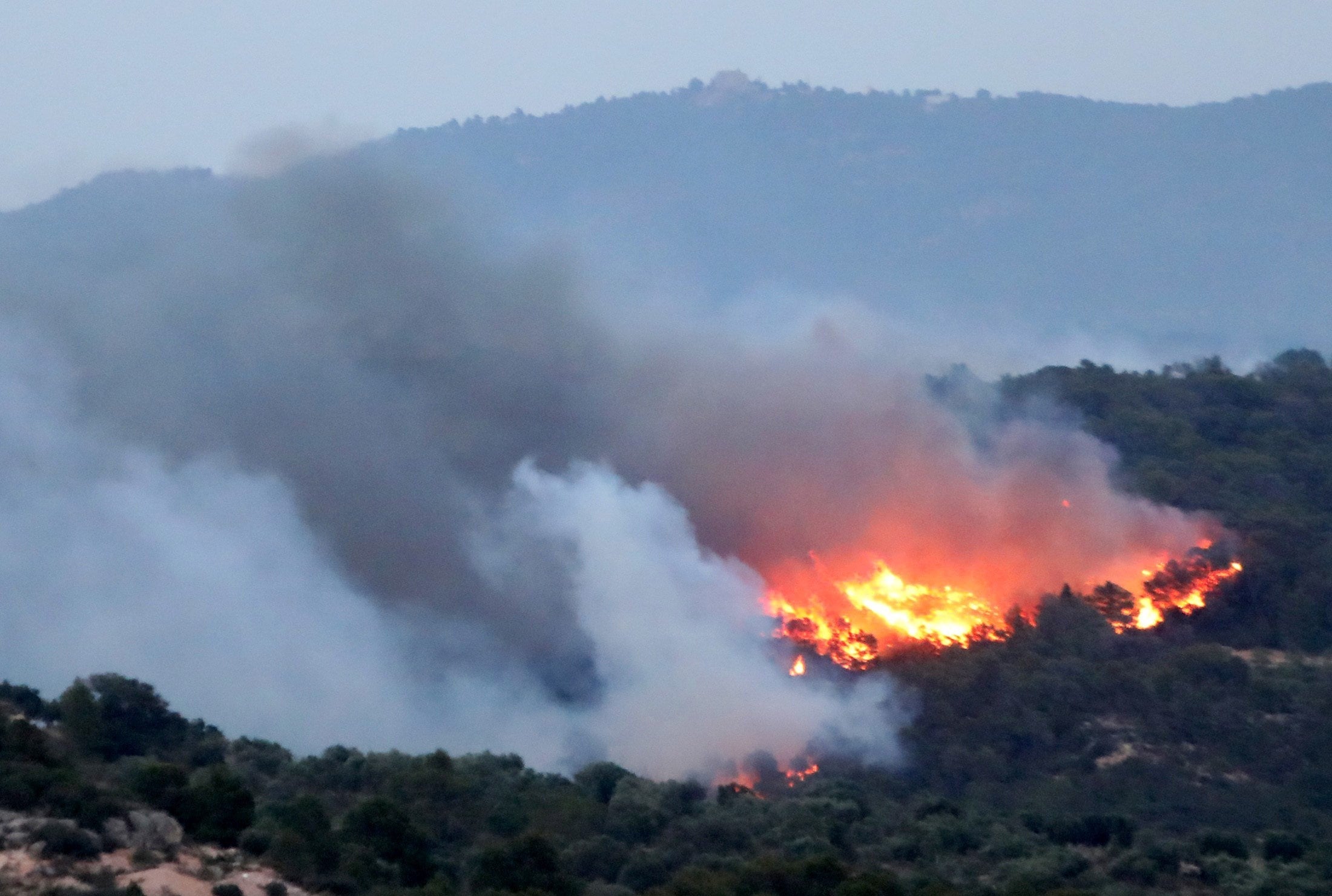 A forest fire burns in Tarragona, Catalonia, as temperatures continue to soar across Europe