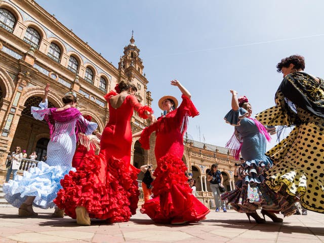 <p>Young women dance flamenco on Plaza de Espana during famous Feria festival</p>