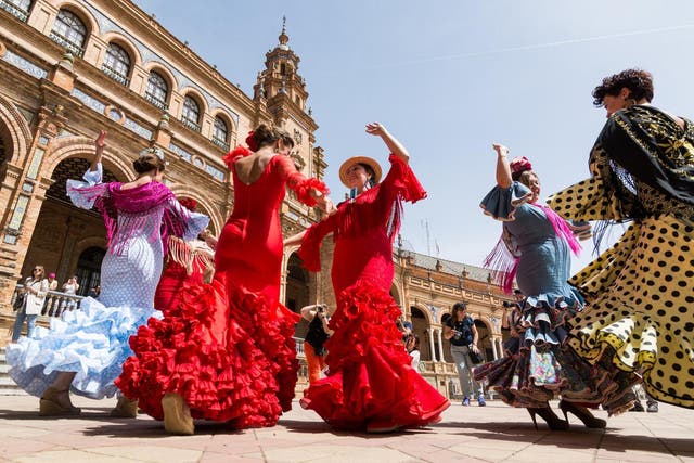 <p>Young women dance flamenco on Plaza de Espana during famous Feria festival</p>