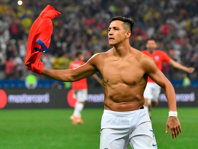 Alexis Sanchez celebrates scoring Chile's winning penalty in their shootout victory over Colombia