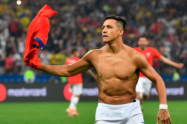 Alexis Sanchez celebrates scoring Chile's winning penalty in their shootout victory over Colombia