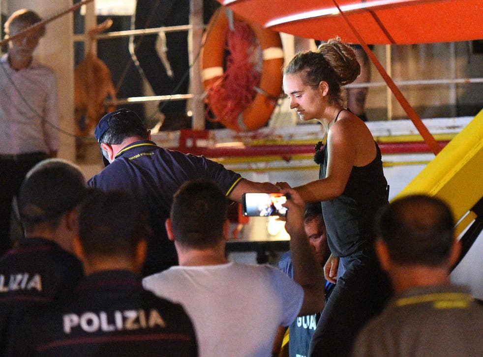 Carola Rackete, captain of Sea-Watch 3, is escorted off the ship in Lampedusa, Italy