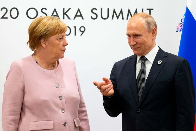 Angela Merkel chats to Russian president Vladimir Putin at the G20 Summit in Osaka