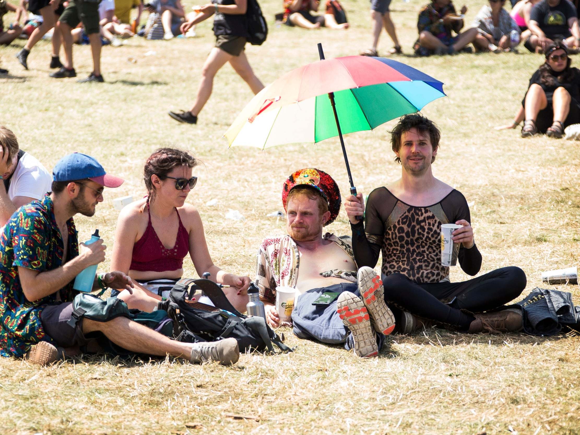 Festival goers take shelter from the sun on the fourth day of Glastonbury Festival 2023