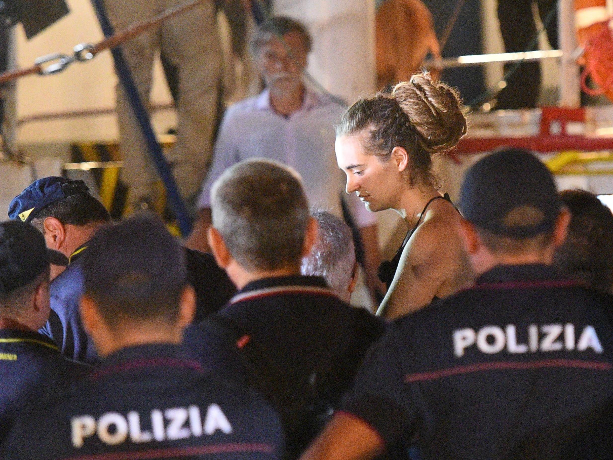 Carola Rackete, the 31-year-old Sea-Watch 3 captain, is escorted off the ship by police and taken away for questioning, in Lampedusa, Italy on 29 June 2019.