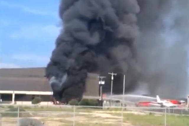 A video taken immediately after the crash shows the burning hangar at Addison Municipal Airport