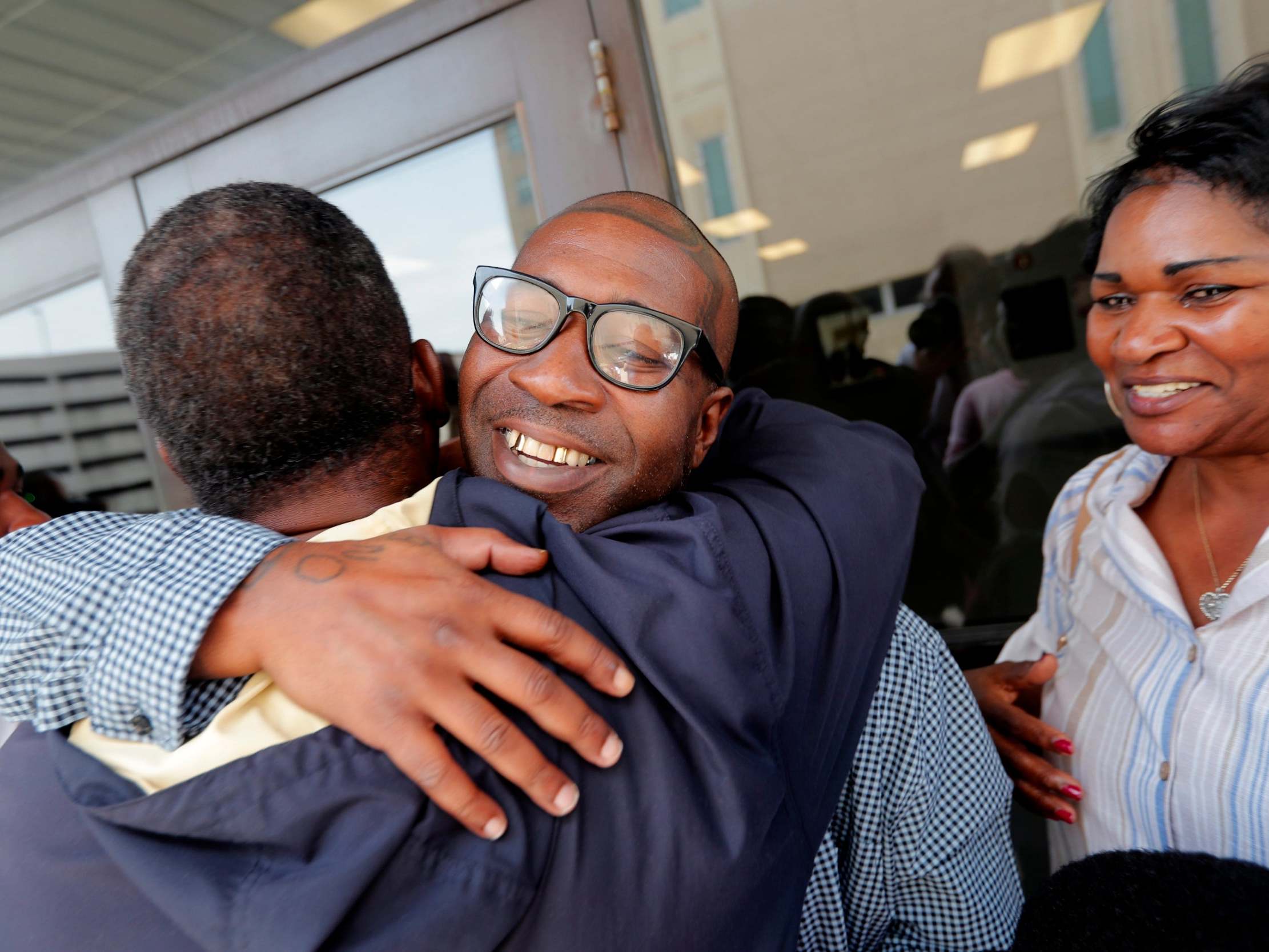 Royal Clark Jr hugs his father outside the Jefferson Parish jail, after he was freed from his 49-year sentence over an armed robbery he did not commit