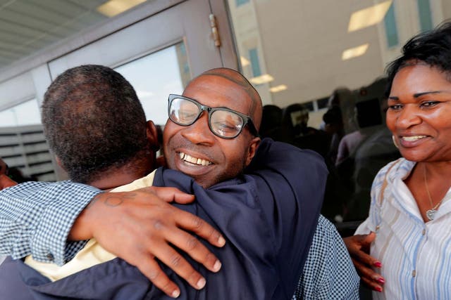 Royal Clark Jr hugs his father outside the Jefferson Parish jail, after he was freed from his 49-year sentence over an armed robbery he did not commit