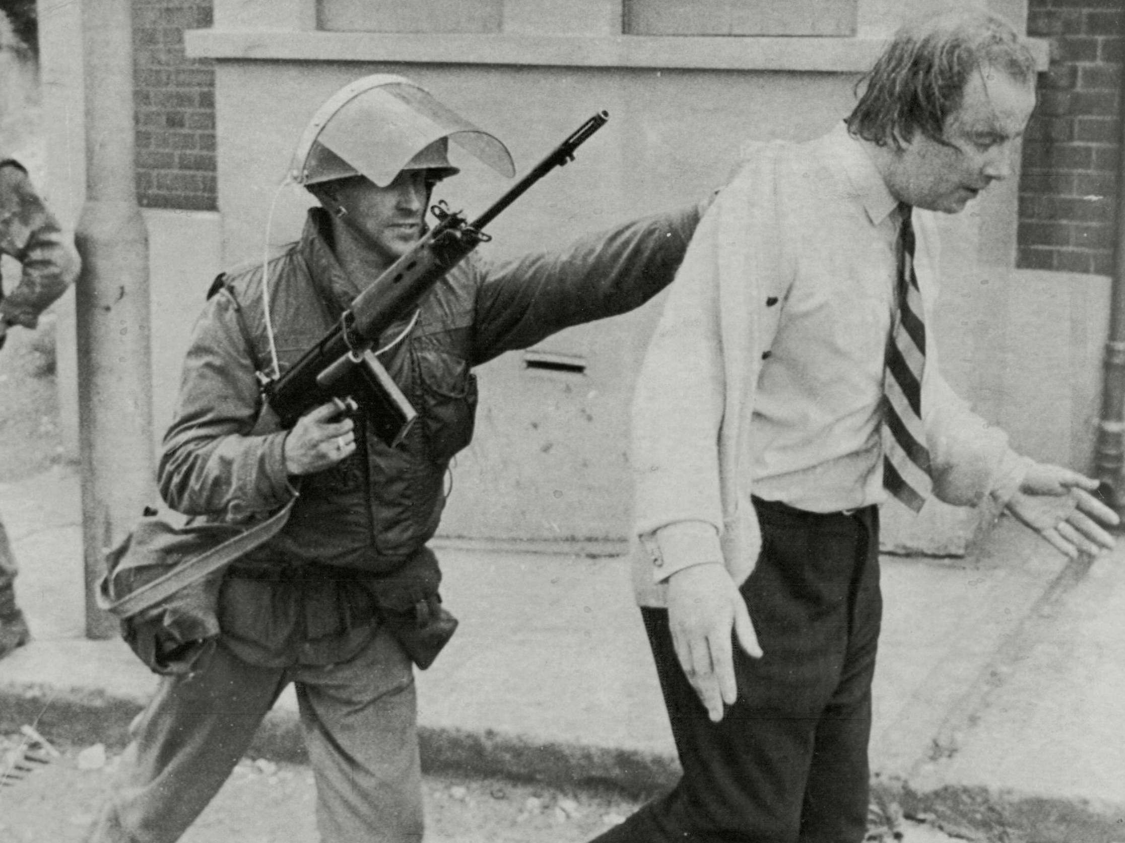 Cooper is escorted from rioting in Derry on 18 August 1971