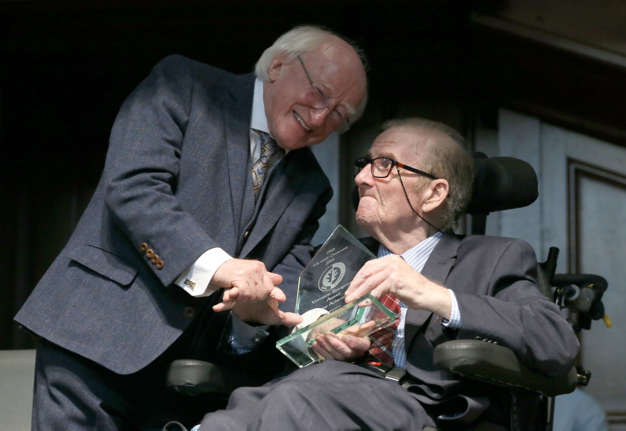 Irish president Michael D Higgins presents an award to Cooper during the commemoration of the 50th anniversary of a Derry march which was attacked by police